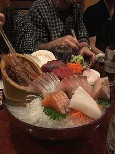 Sushi on a plate at a restaurant.